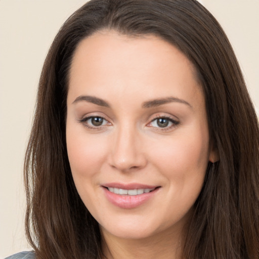 Joyful white young-adult female with long  brown hair and brown eyes