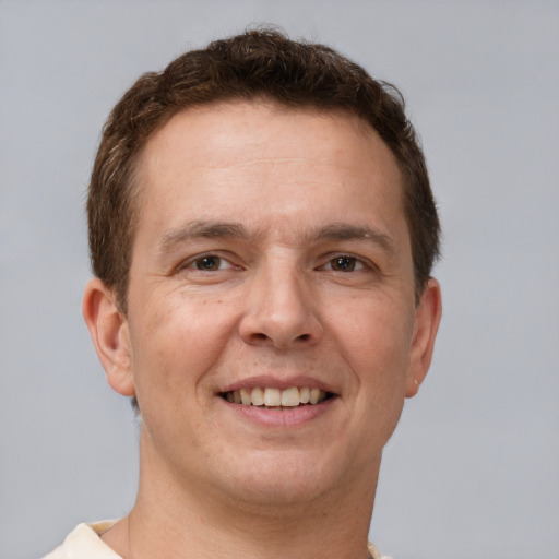 Joyful white adult male with short  brown hair and brown eyes