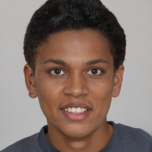 Joyful black young-adult female with short  brown hair and brown eyes