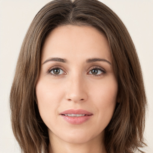 Joyful white young-adult female with long  brown hair and brown eyes