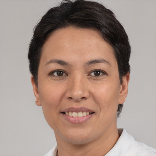 Joyful asian adult female with short  brown hair and brown eyes