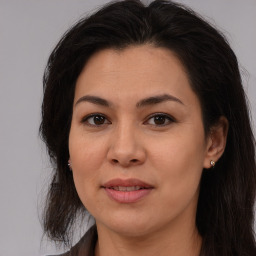 Joyful asian young-adult female with long  brown hair and brown eyes