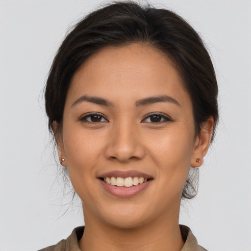 Joyful latino young-adult female with medium  brown hair and brown eyes