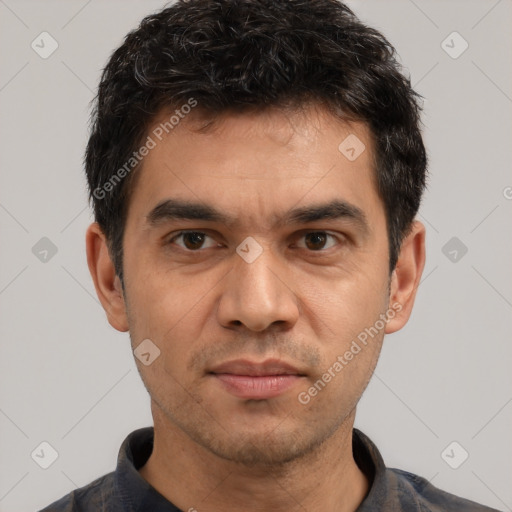 Joyful white adult male with short  black hair and brown eyes