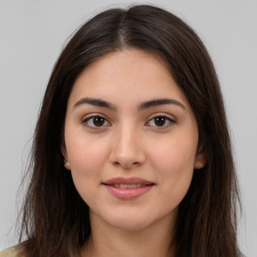 Joyful white young-adult female with long  brown hair and brown eyes