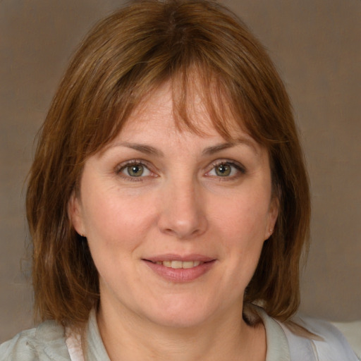 Joyful white young-adult female with medium  brown hair and blue eyes