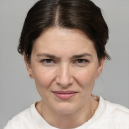 Joyful white adult female with short  brown hair and brown eyes