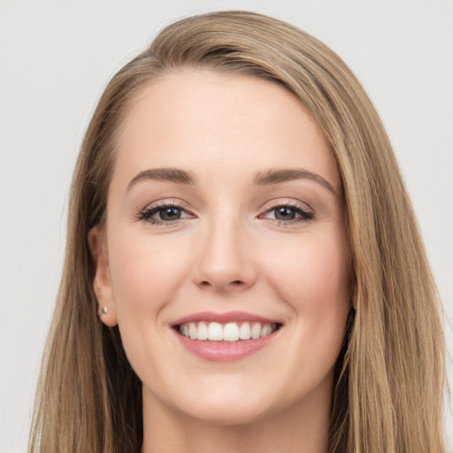 Joyful white young-adult female with long  brown hair and grey eyes