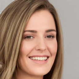 Joyful white young-adult female with long  brown hair and green eyes