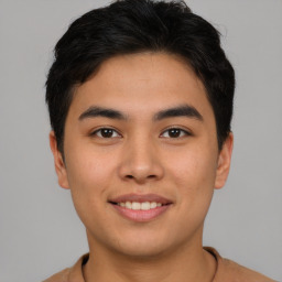 Joyful asian young-adult male with short  brown hair and brown eyes