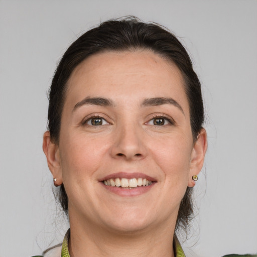 Joyful white adult female with medium  brown hair and grey eyes