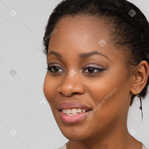 Joyful black young-adult female with long  brown hair and brown eyes