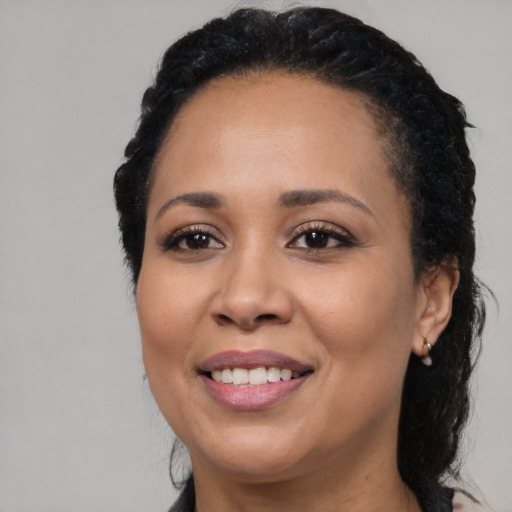 Joyful latino adult female with long  black hair and brown eyes