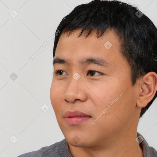 Joyful asian young-adult male with short  black hair and brown eyes