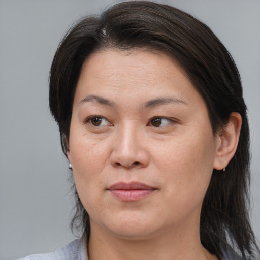 Joyful asian adult female with medium  brown hair and brown eyes