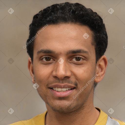 Joyful latino young-adult male with short  black hair and brown eyes