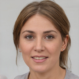 Joyful white young-adult female with medium  brown hair and grey eyes