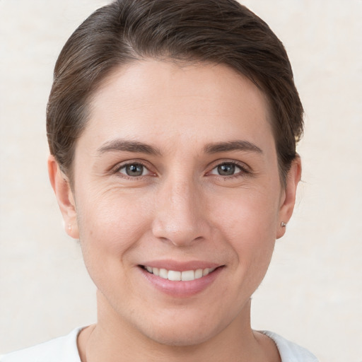 Joyful white young-adult female with short  brown hair and brown eyes