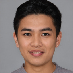 Joyful asian young-adult male with short  brown hair and brown eyes