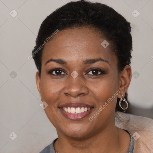 Joyful black young-adult female with short  brown hair and brown eyes