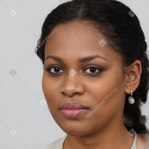 Joyful black young-adult female with long  black hair and brown eyes