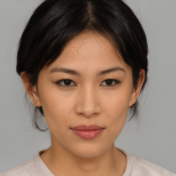 Joyful asian young-adult female with medium  brown hair and brown eyes