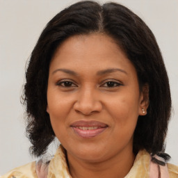 Joyful black adult female with medium  brown hair and brown eyes