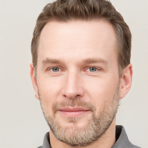 Joyful white adult male with short  brown hair and grey eyes