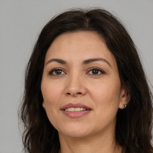 Joyful white adult female with long  brown hair and brown eyes