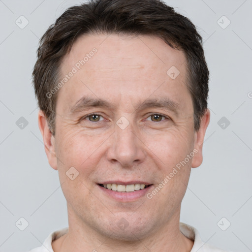 Joyful white adult male with short  brown hair and brown eyes