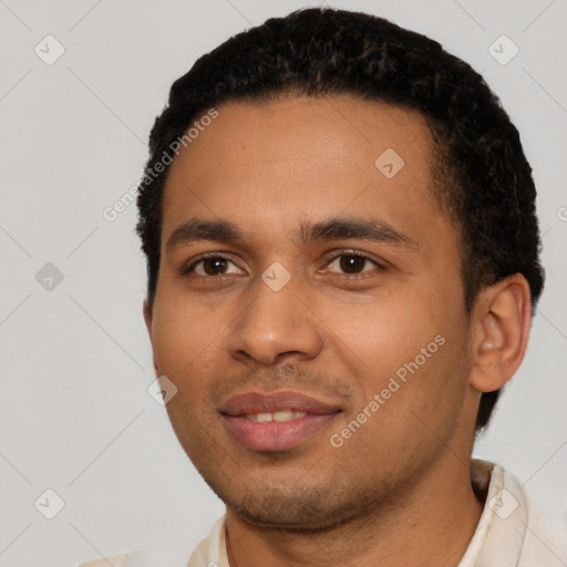 Joyful latino young-adult male with short  black hair and brown eyes