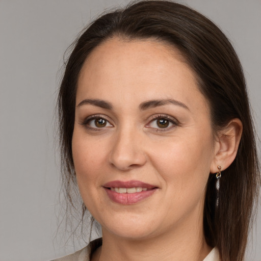 Joyful white adult female with long  brown hair and brown eyes