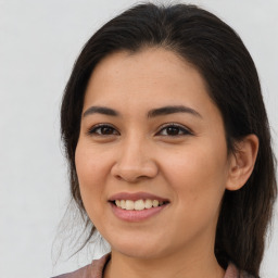 Joyful latino young-adult female with long  brown hair and brown eyes