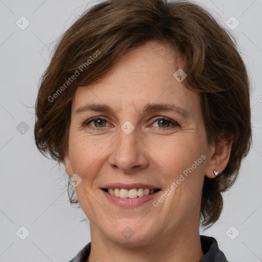 Joyful white adult female with medium  brown hair and grey eyes