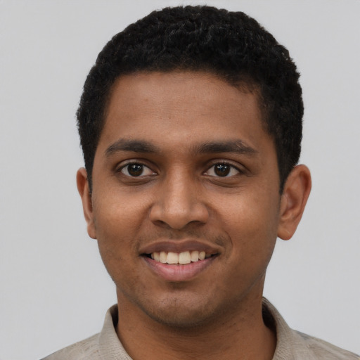 Joyful black young-adult male with short  black hair and brown eyes