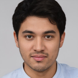 Joyful white young-adult male with short  black hair and brown eyes