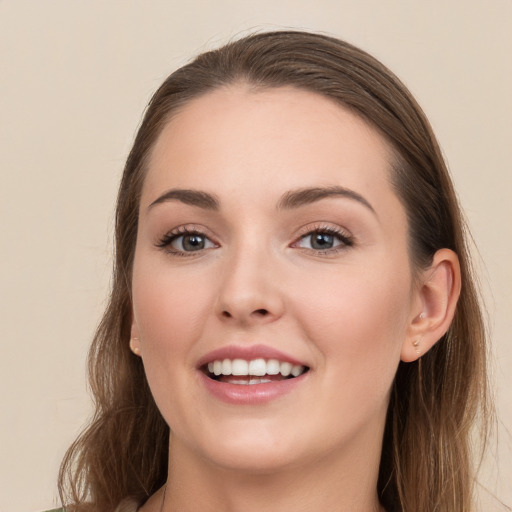 Joyful white young-adult female with long  brown hair and grey eyes