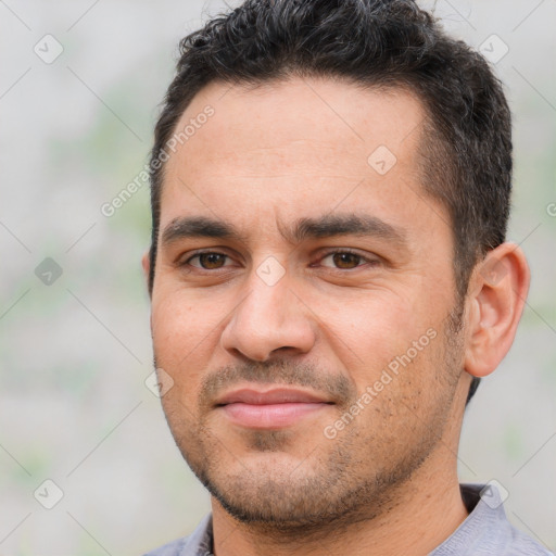 Joyful white young-adult male with short  black hair and brown eyes