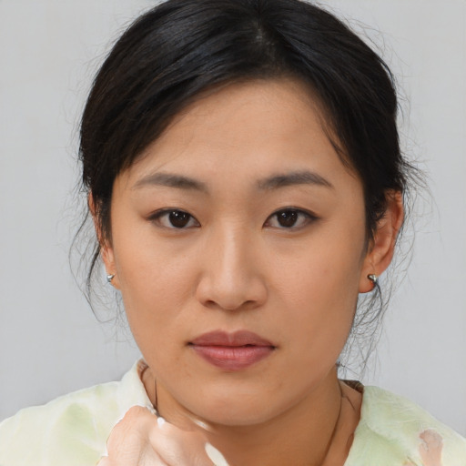 Neutral asian young-adult female with medium  brown hair and brown eyes