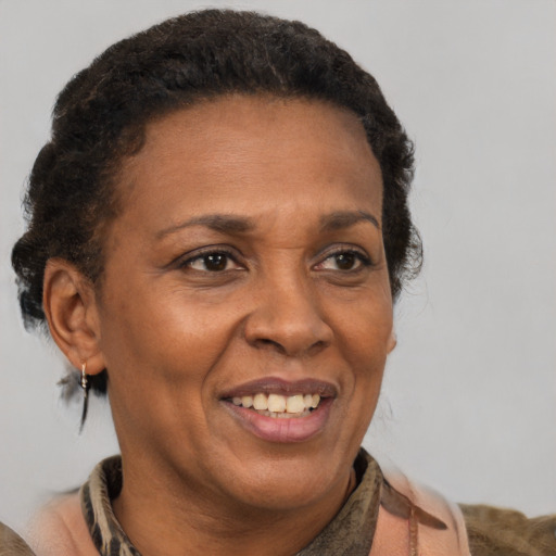 Joyful black adult female with short  brown hair and brown eyes