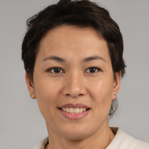 Joyful white adult female with short  brown hair and brown eyes