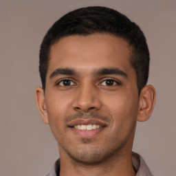 Joyful latino young-adult male with short  brown hair and brown eyes