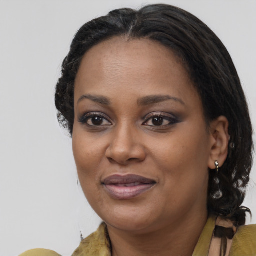 Joyful black adult female with medium  brown hair and brown eyes