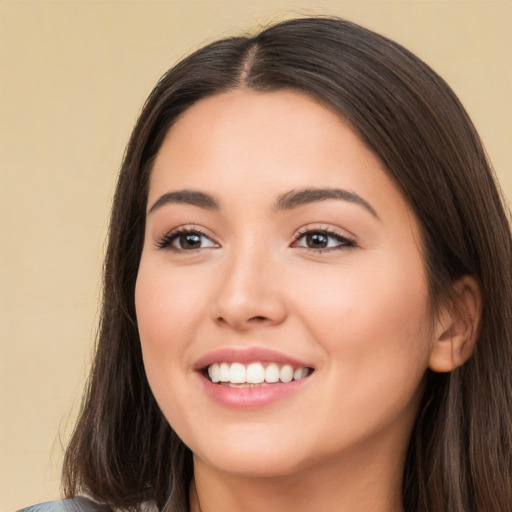 Joyful white young-adult female with long  brown hair and brown eyes