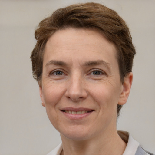 Joyful white adult female with short  brown hair and grey eyes