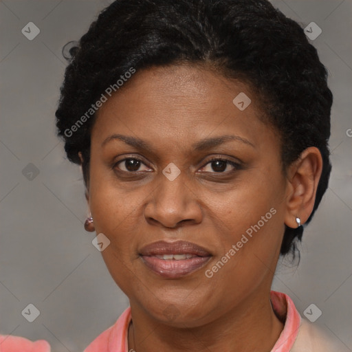 Joyful black adult female with short  brown hair and brown eyes