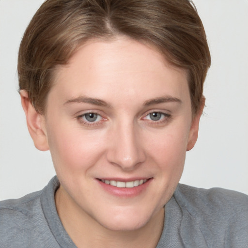 Joyful white young-adult female with short  brown hair and grey eyes