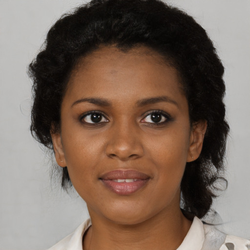 Joyful black young-adult female with medium  black hair and brown eyes