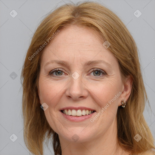 Joyful white adult female with medium  brown hair and blue eyes