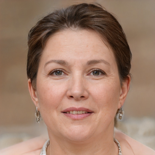 Joyful white adult female with medium  brown hair and brown eyes